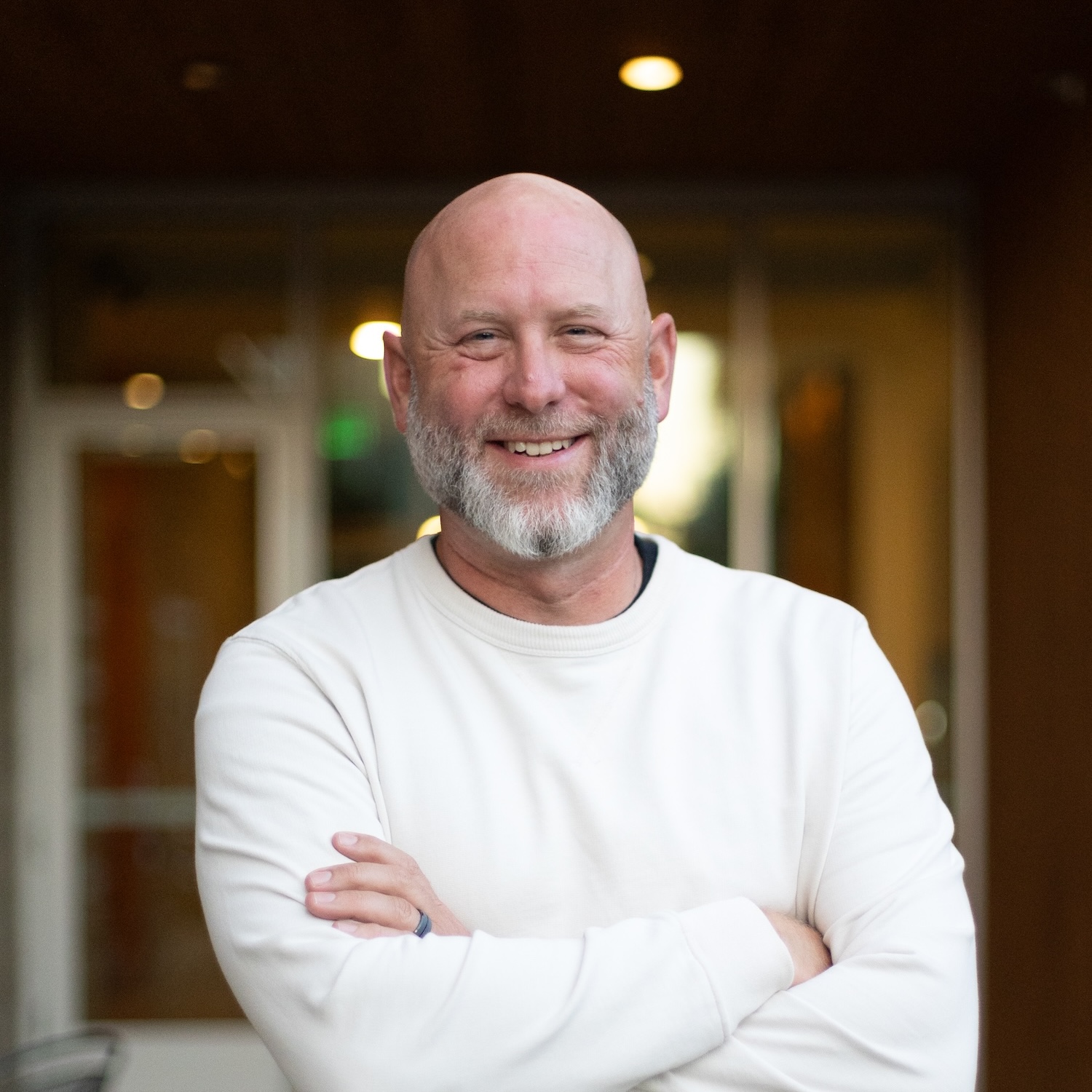 Todd Hiestand, smiling with his arms crossed